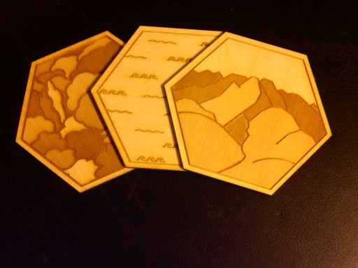 Three tiles from a lasercut wood tile set for Settlers of Catan